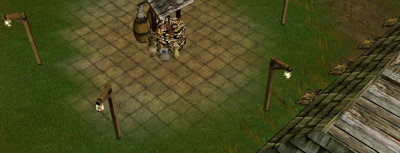The caravan town of Promiseland: a stone well on a paved square, with lanterns round it