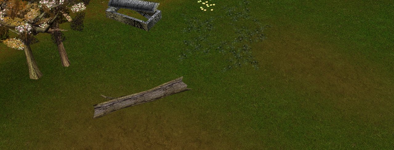 Broken statues and a stone tomb on the grass by the walls of an old fort